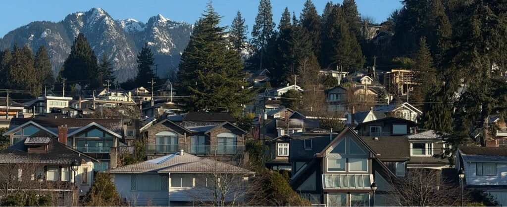 West Vancouver Irrigation Services: Expert Installation, Repair, and Maintenance A residential neighborhood in West Vancouver with houses nestled amongst trees and mountains