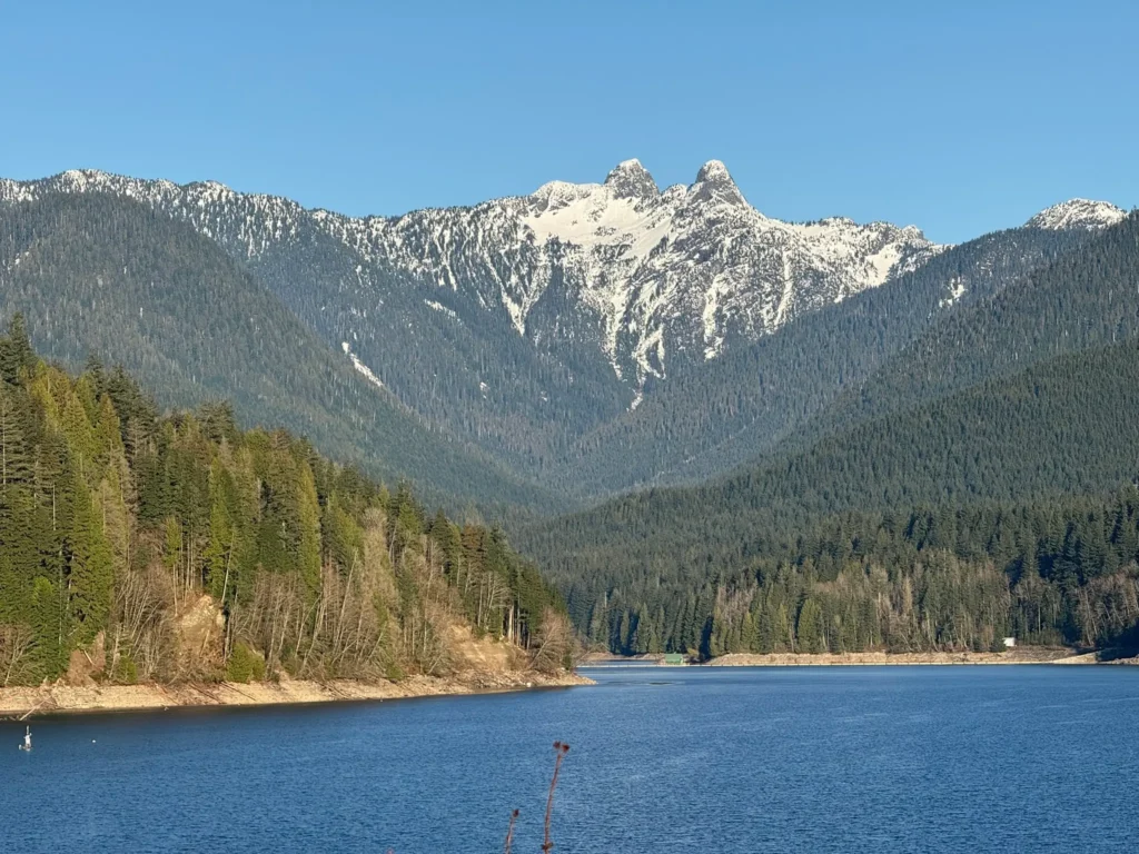 View of the Capilano Reservoir and The Lions mountains in North Vancouver, representing the local water source for irrigation.